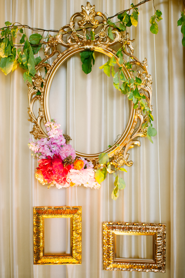 Vintage inspired gold frames hanging as wedding decor - Photo by Dan Stewart Photography